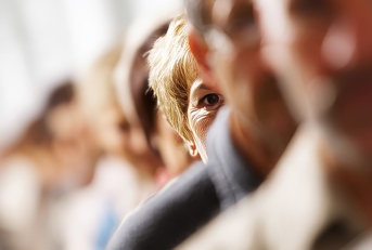 A woman out of focus with a group of people