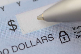 close up of pen writing the dollar amount