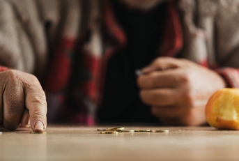 Poor senior man is counting change