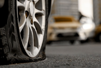 Close-up of a flat tire on a car