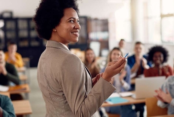 teacher getting applause from her students