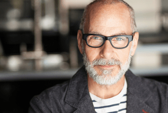man in his 50&#x27;s with glasses looking into the camera