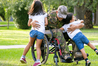 Disabled veteran hugging children