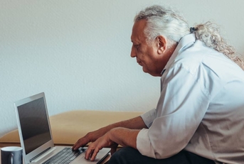 Older man working on laptop