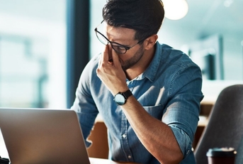 Stressed, tired and frustrated business man with headache at night from burnout or making mistake on laptop. 