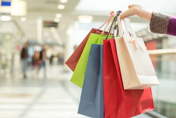 crop hand holding shopping bags