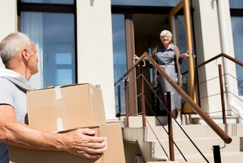 senior couple unloading cardboard boxes