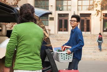young man moving into dormitory
