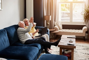 Senior couple on a sofa in the living room of their home