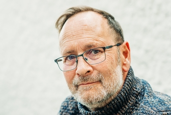 portrait of 50 year old man wearing brown pullover