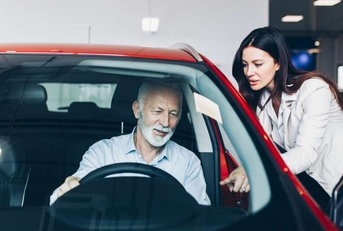 man choosing a new car at car showroom