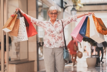 woman holding shopping bags looking happy