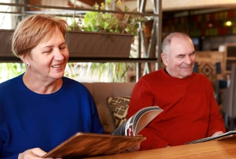 Senior couple with menu books in restaurant