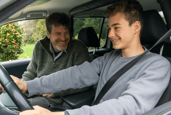 Father teaching teen son to drive