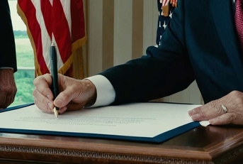 presidents hand signing official documents