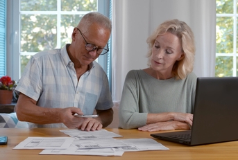 Senior couple scan qr-code to pay bill