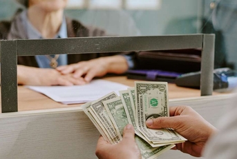 bank clerk handling financial transaction