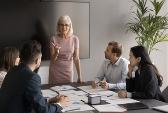 manager makes speech in front of employees at the office