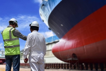 Engineers discuss ship repair plans on the dock
