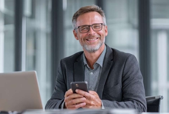 smiling businessman holding smartphone