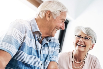 happy senior couple in home planning for retirement