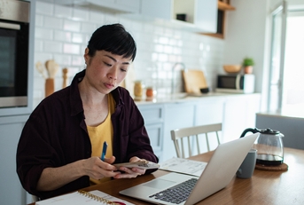 stressed woman reviewing bills and finances