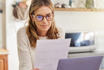 woman reading financial document