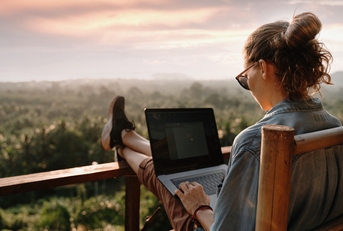 businesswoman working on laptop in cafe on the rock