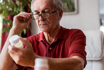 Senior man taking prescription medicine