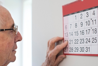 Older man looking at calendar