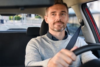 happy mature man driving car 