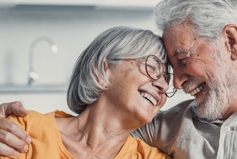 Senior couple smiling and hugging each other