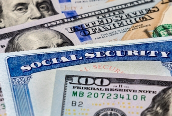 social security benefits identification card with dollar bills
