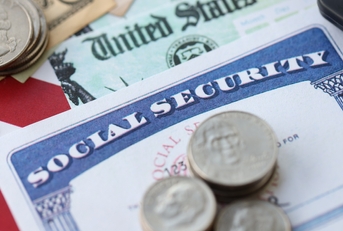 social security number card and calculator on American flag