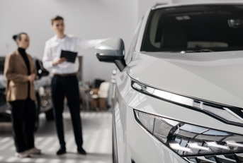 car dealer advises a customer on buying a new car