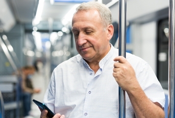 Man in the subway looking at his phone