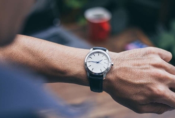 checking luxury watch to check time