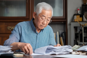 elderly man organizing documents