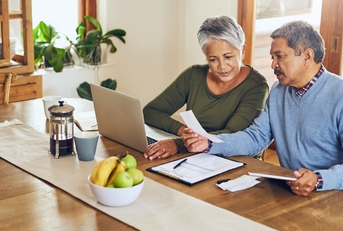 senior couple with bills