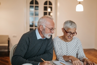 senior couple calculating their expenses
