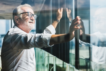 businessman standing near office window
