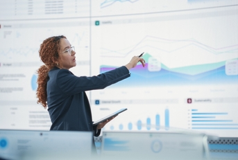 female data scientist reviewing reports