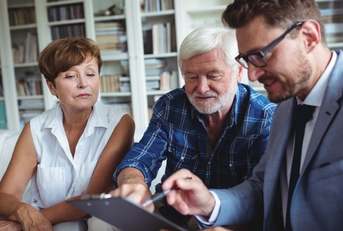 senior couple consulting with financial advisor