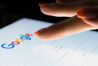 A woman&#x27;s hand is touching screen on tablet