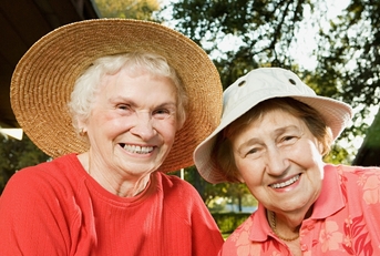 Two senior women smiling in the garden