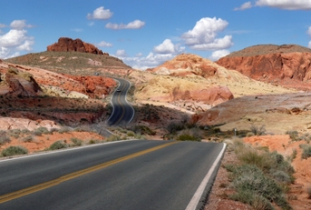 Nevada road cutting through desert mountains
