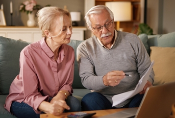 elderly couple reviewing life insurance documents
