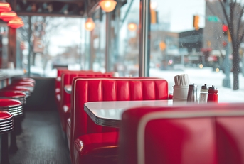 Interior view of a diner with red booths and stools