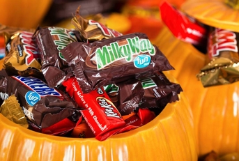 Decorative pumpkins filled with assorted Halloween candy
