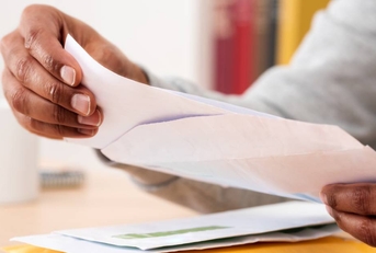 Hands holding check from envelope